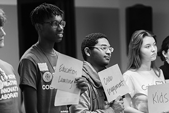 Students holding papers