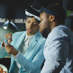 Two young professionals looking at a computer chip