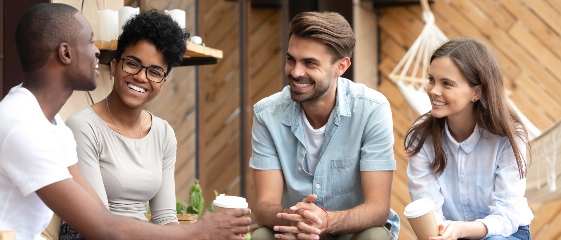 Group of people laughing and enjoying coffee