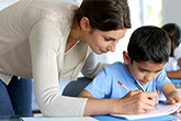 Teacher helping a child with classwork