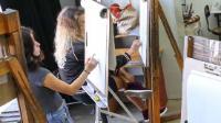 Students painting on easels