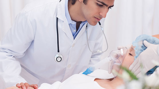 Respiratory Care Technician putting a respirator on a patient